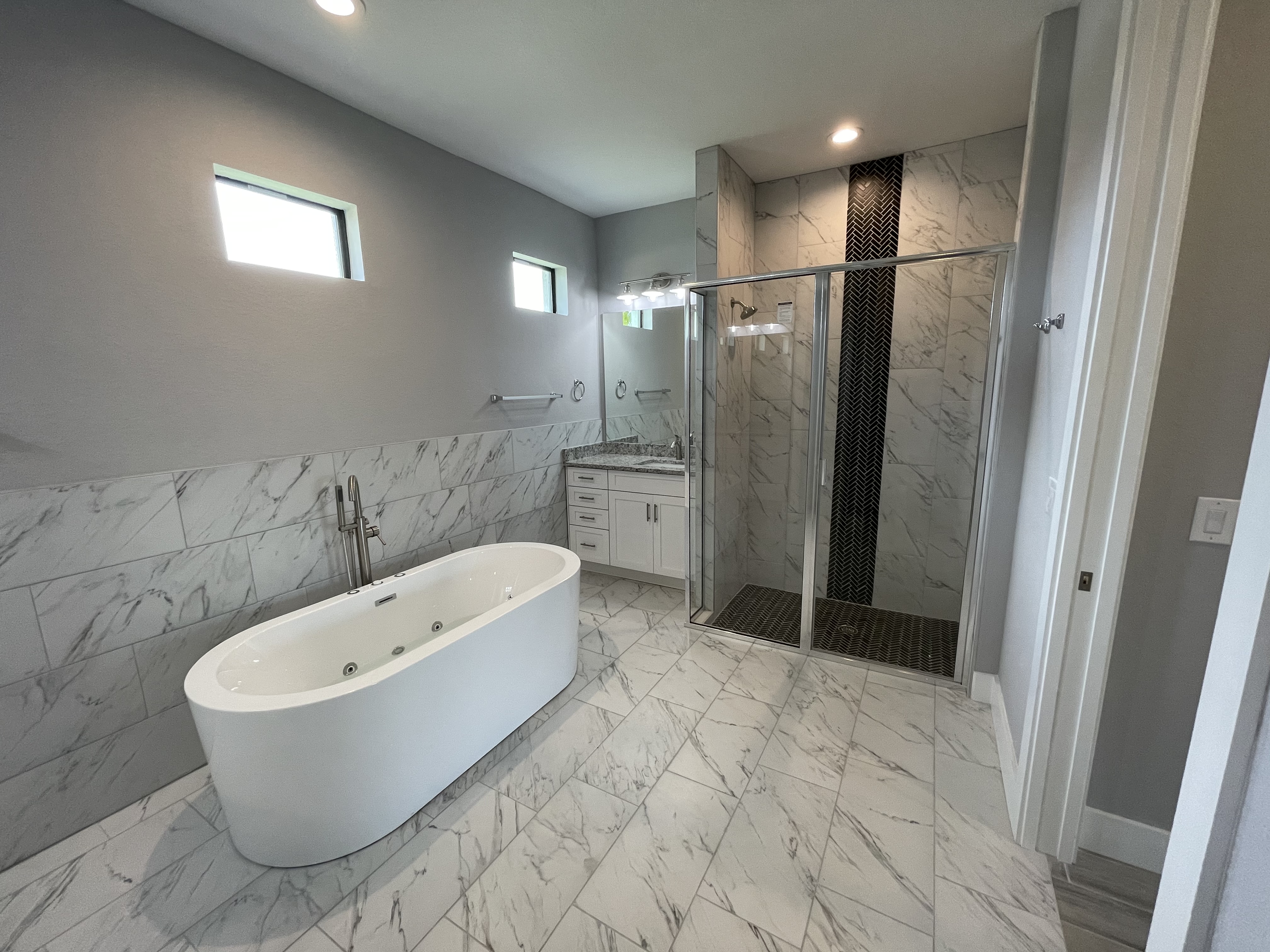 Raven master bath shower with herringbone accent