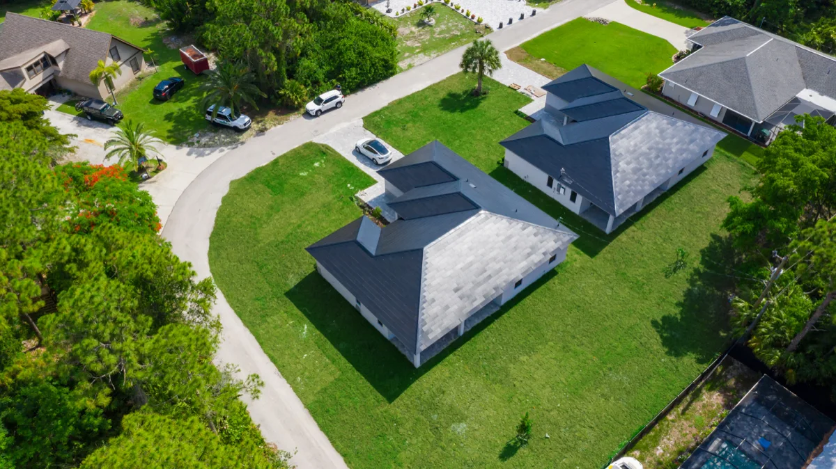 Aerial view of two PrimeBid custom homes under construction in Southwest Florida